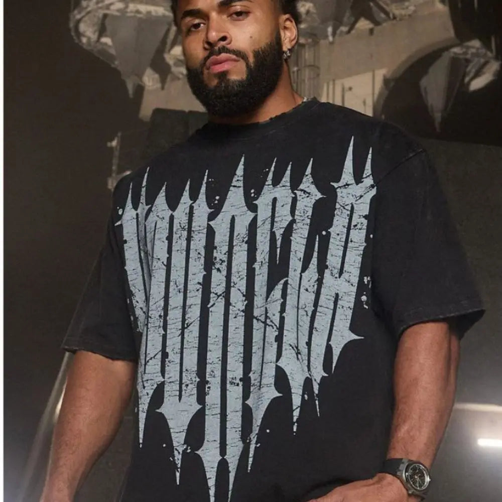 Man wearing Active Comfort Tee in black with bold logo design, showcasing style and versatility.