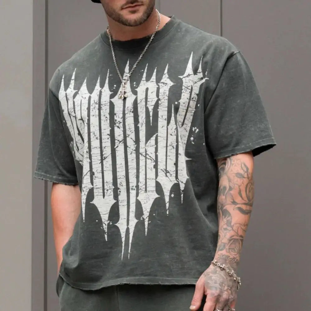 Man wearing an oversized graphic t-shirt with a bold design, showcasing urban fashion style.