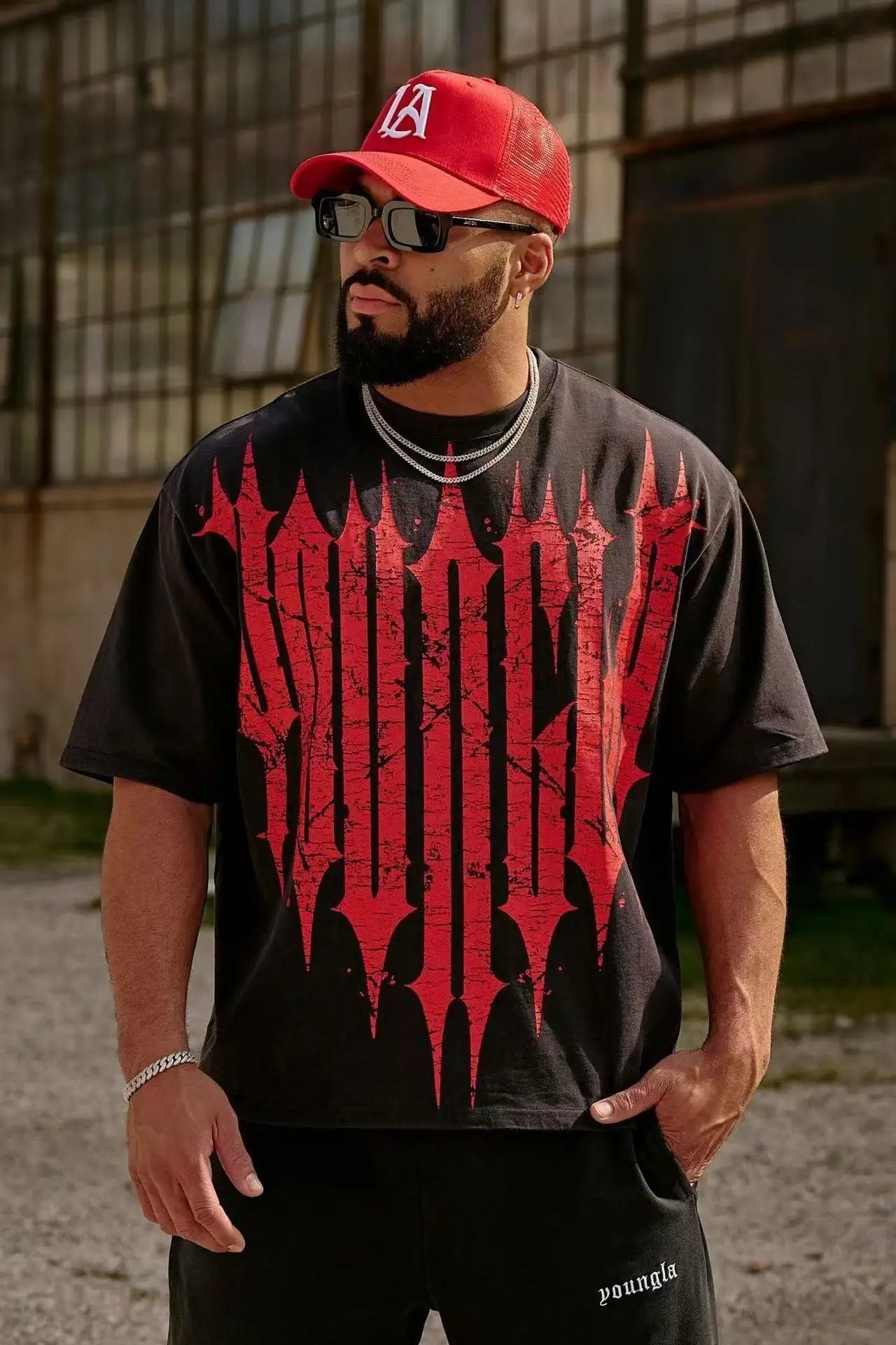 Stylish man wearing an Active Comfort Tee™ with bold red graphics, perfect for casual outings and an active lifestyle.